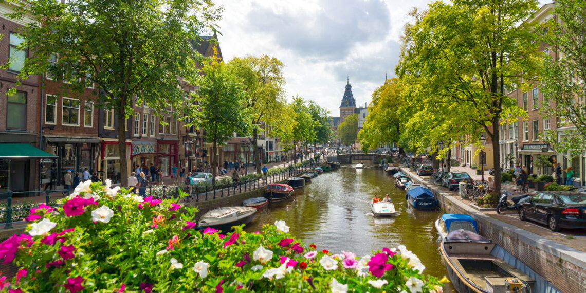 AMSTERDAM - AUGUST 29: Canal in old city at daytime on August 29, 2014 in Amsterdam.