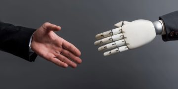 Aperto de mão com robô com IA - Créditos: depositphotos.com / VitalikRadko