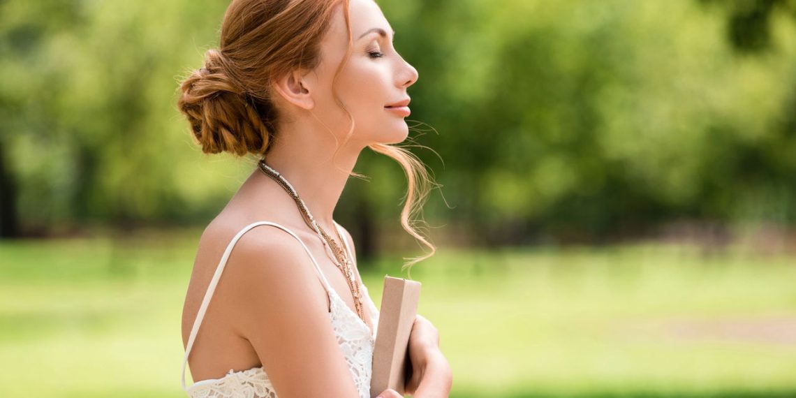 Mulher com livro no parque - Créditos: depositphotos.com / ArturVerkhovetskiy