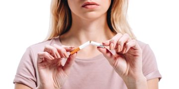 Mulher quebrando cigarro ao meio - Créditos: depositphotos.com / EdZbarzhyvetsky