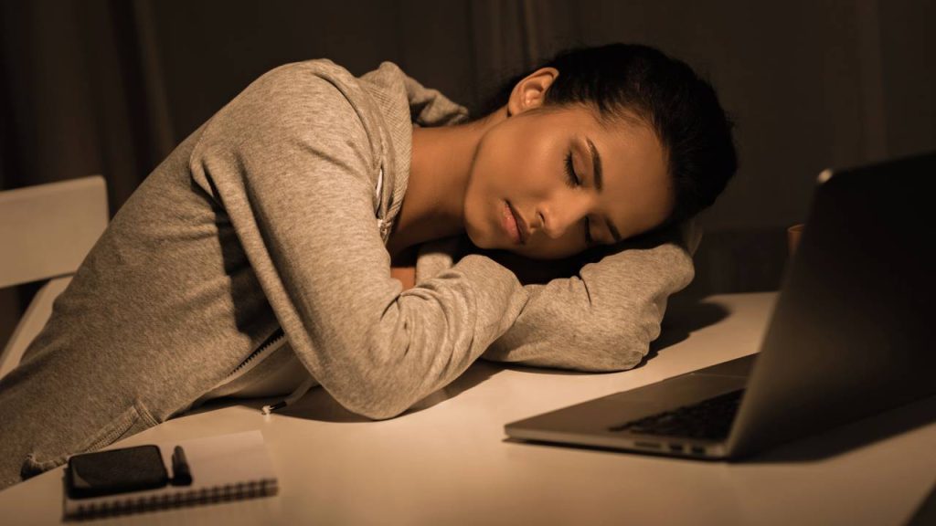 Jovem dormindo na mesa de estudo porque virou a noite - Créditos: depositphotos.com / AllaSerebrina