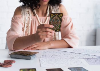 Astróloga com cartas de tarô - Créditos: depositphotos.com / IgorVetushko